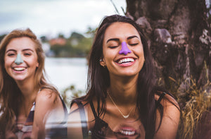 Two girls laughing wearing Nöz sunscreen